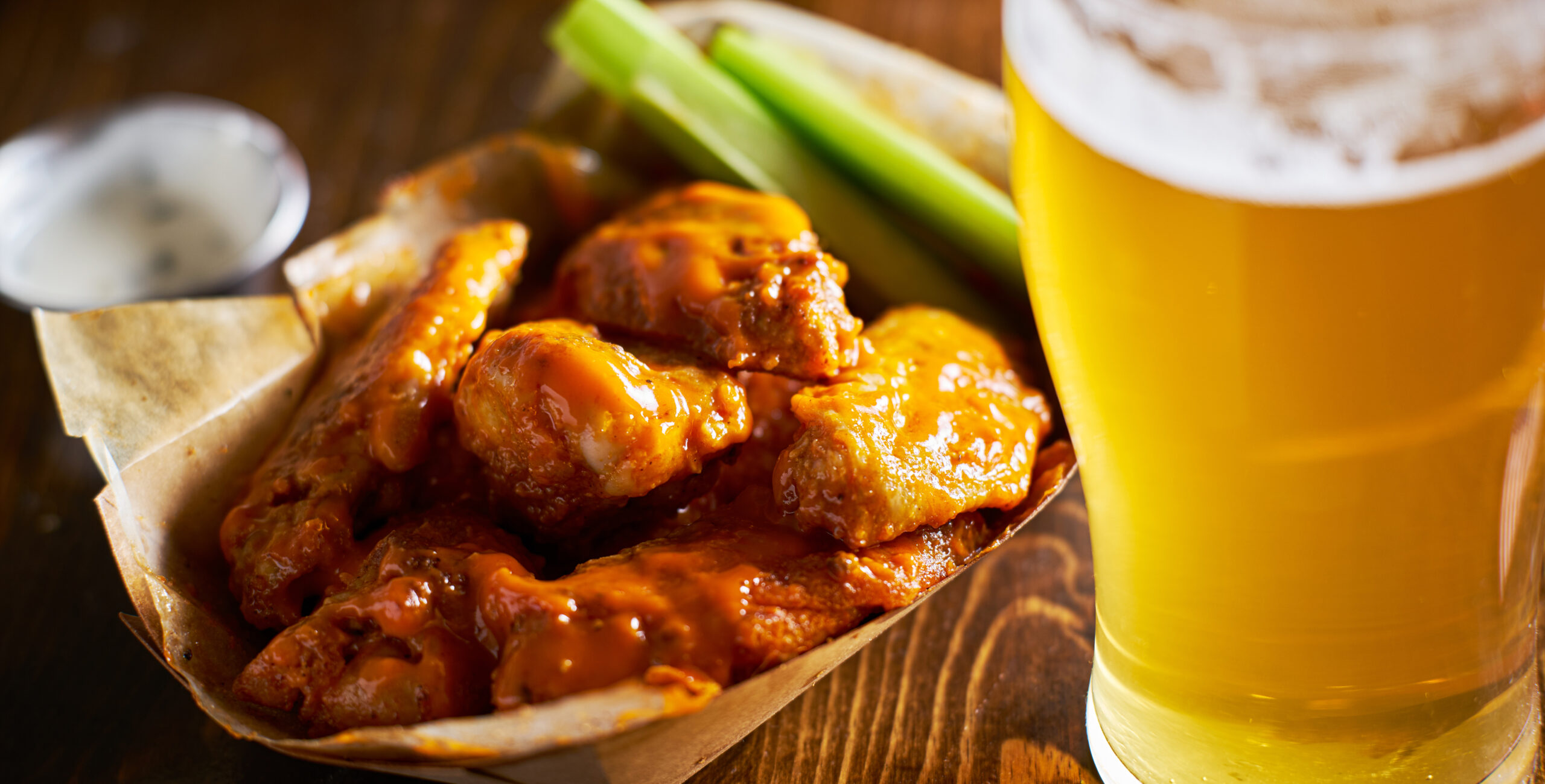 Buffalo wings and a beer on a restaurant table