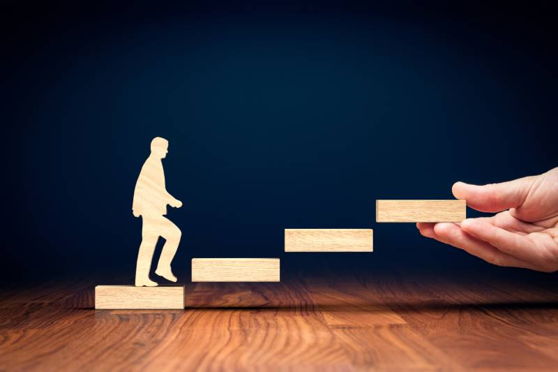 A figure climbing a set of block steps